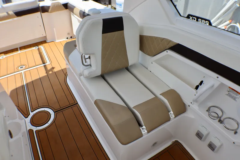 Slide: The Image of 2023 Edgewater 262CX Crossover boat interior with tan and white seating. - 47