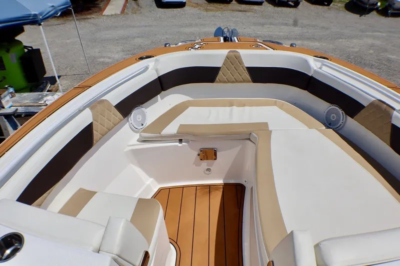 Slide: The Image of Luxurious seating area on 2023 Edgewater 262CX Crossover boat, featuring tan and white upholstery. - 42