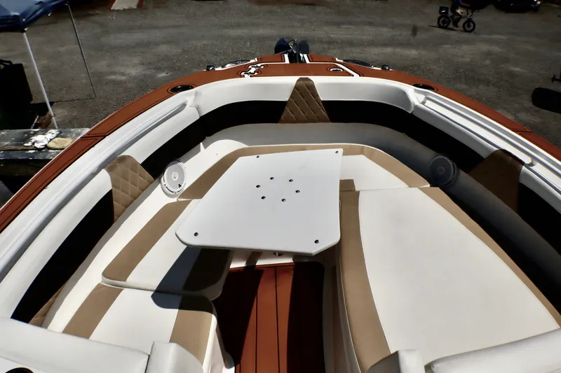 Slide: The Image of 2023 Edgewater 262CX Crossover boat interior with seating and table. - 38