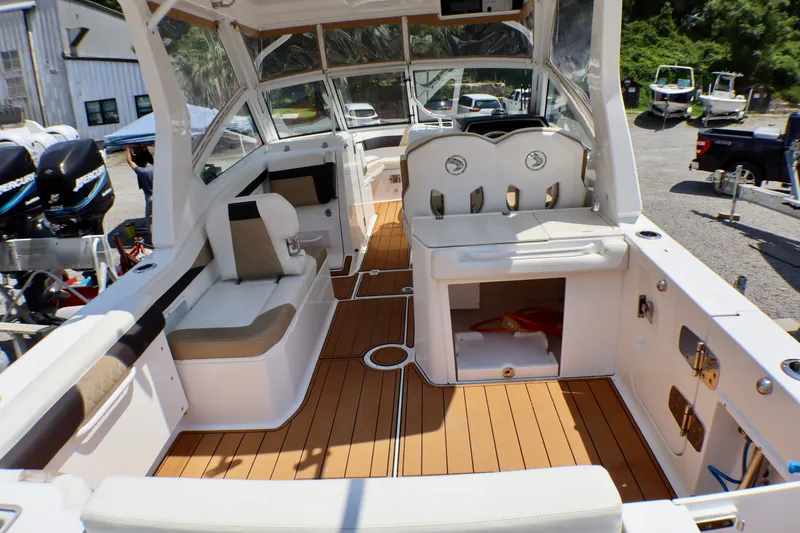 Slide: The Image of 2023 Edgewater 262CX Crossover boat interior with seating and storage compartments. - 19
