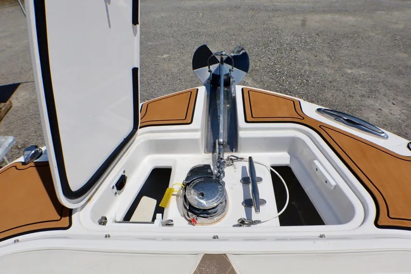 Slide: The Image of Anchor compartment of 2023 Edgewater 262CX Crossover boat with open hatch. - 43
