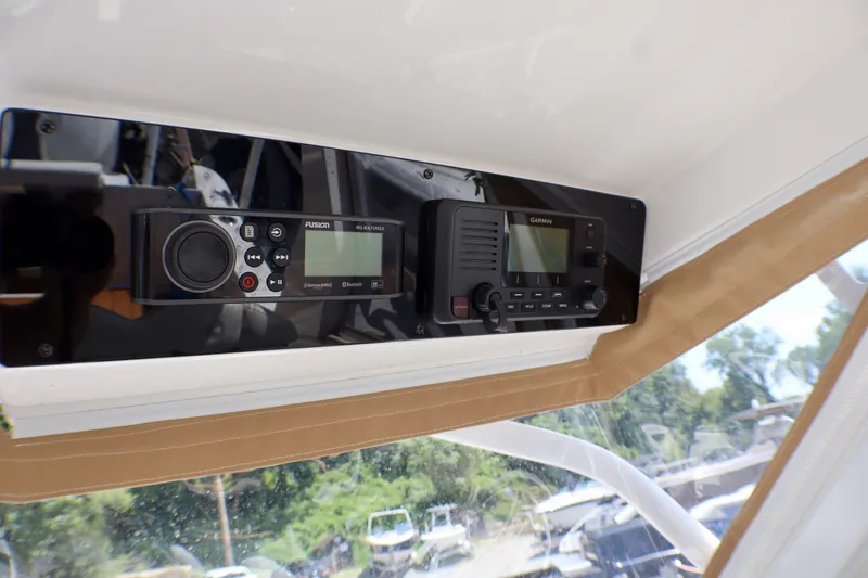 Slide: The Image of 2023 Edgewater 262CX Crossover boat dashboard with Garmin and Fusion electronics. - 46