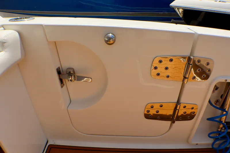 Slide: The Image of 2023 Edgewater 262CX Crossover boat door with stainless steel hinges and latch. - 45