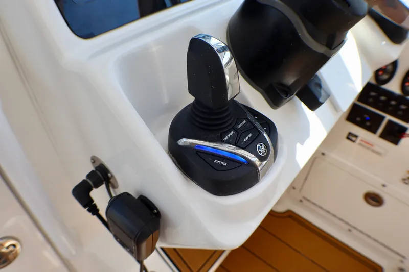 Slide: The Image of Joystick control on 2023 Edgewater 262CX Crossover boat dashboard, featuring Yamaha branding. - 32