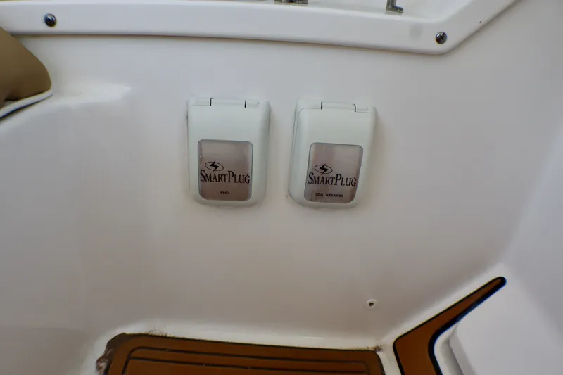 Slide: The Image of SmartPlug outlets on 2023 Edgewater 262CX Crossover boat, featuring secure electrical connections. - 41