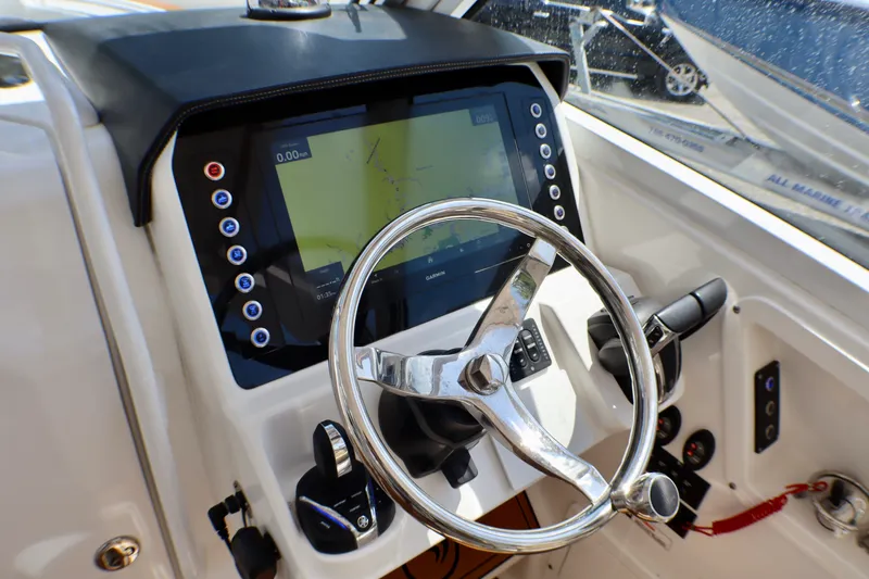 Slide: The Image of Helm of 2023 Edgewater 262CX Crossover boat with modern navigation display. - 29