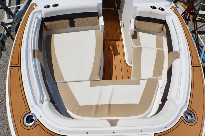 Slide: The Image of 2023 Edgewater 262CX Crossover boat interior with beige and white seating. - 35