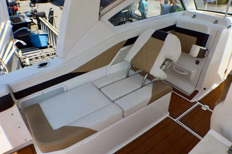 Slide: The Image of Interior of 2023 Edgewater 262CX Crossover boat with luxurious seating and wood flooring. - 25