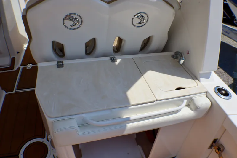 Slide: The Image of 2023 Edgewater 262CX Crossover boat interior with seating and storage compartments. - 26