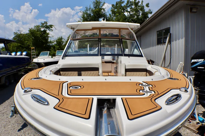 Slide: The Image of 2023 Edgewater 262CX Crossover boat with tan deck, docked outdoors. - 17