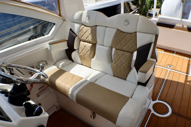 Slide: The Image of 2023 Edgewater 262CX Crossover boat interior with luxurious seating and steering wheel. - 37