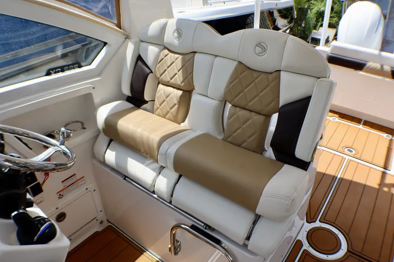 Slide: The Image of Luxurious seating in the 2023 Edgewater 262CX Crossover boat, featuring elegant upholstery design. - 36