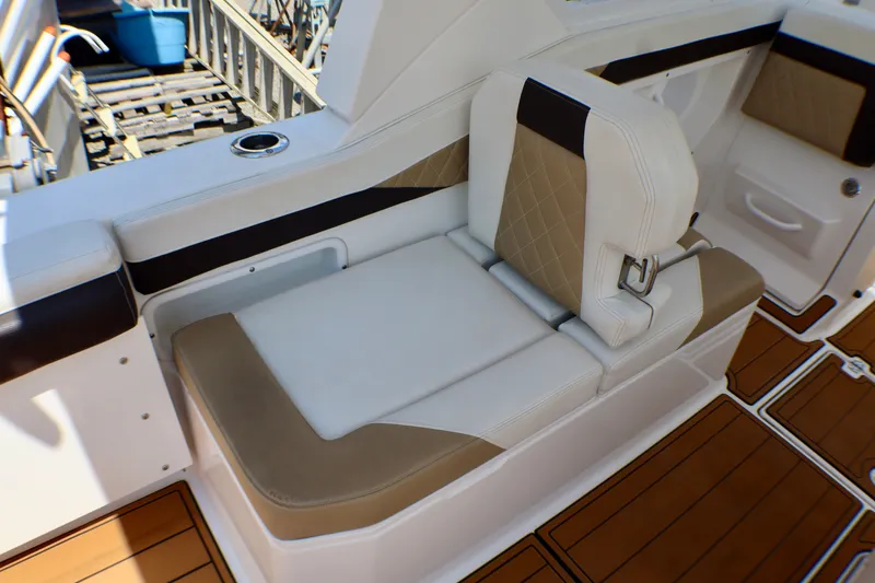 Slide: The Image of Luxurious seating on 2023 Edgewater 262CX Crossover boat with tan and white upholstery. - 23