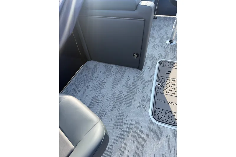 Slide: The Image of 2026 Sylvan L3 ULZ DH boat interior with textured flooring and seating. - 19