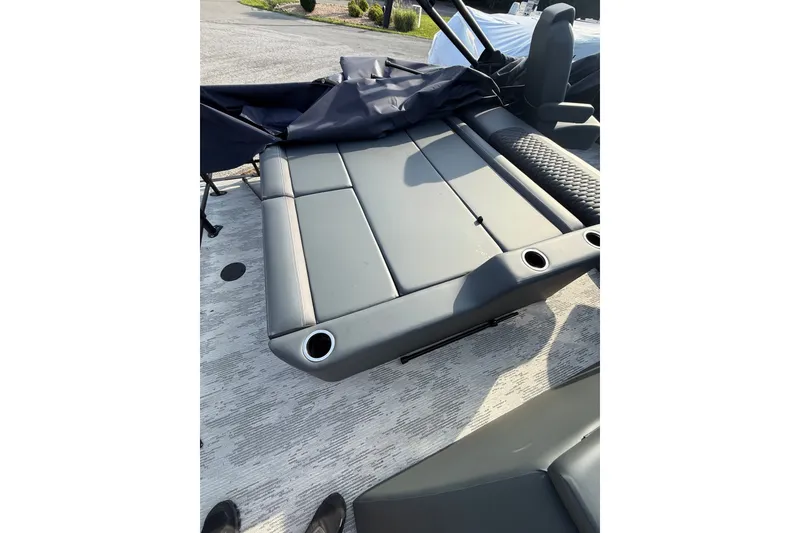 Slide: The Image of 2026 Sylvan L3 ULZ DH boat interior with gray seating and cup holders. - 24