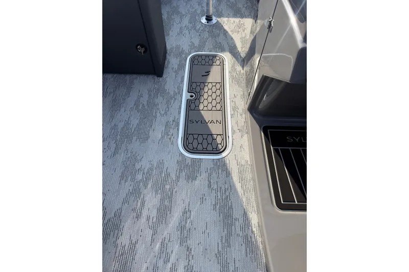 Slide: The Image of 2026 Sylvan L3 ULZ DH boat interior with sleek flooring and branded hatch cover. - 18