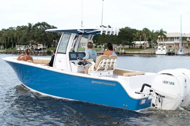 The Image of 2027 Sportsman Open 252 Center Console boat cruising on a calm waterway. - 1
