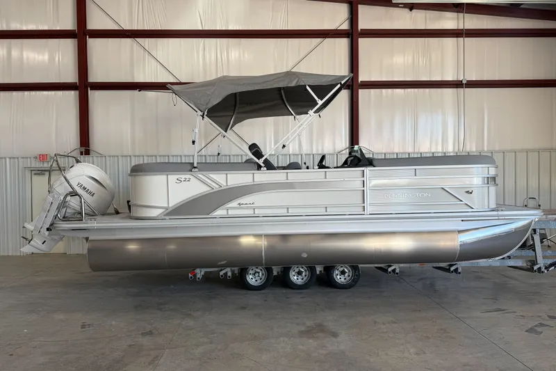 The Image of 2027 Bennington 22 SSR pontoon boat with Yamaha motor in a warehouse setting. - 1