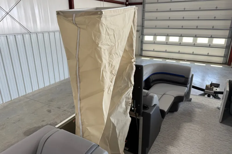 Slide: The Image of 2027 Bennington 22 SSR boat interior with beige privacy curtain and gray seating. - 13