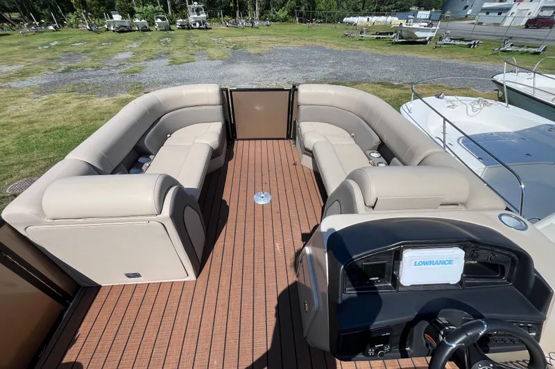 Slide: The Image of 2023 Bentley Pontoons 220 Elite Admiral interior with beige seating and wood-style flooring. - 8