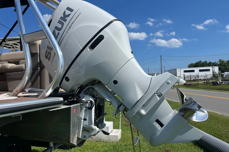 Slide: The Image of 2023 Bentley Pontoons 220 Elite Admiral with Suzuki outboard motor, parked on grass. - 18