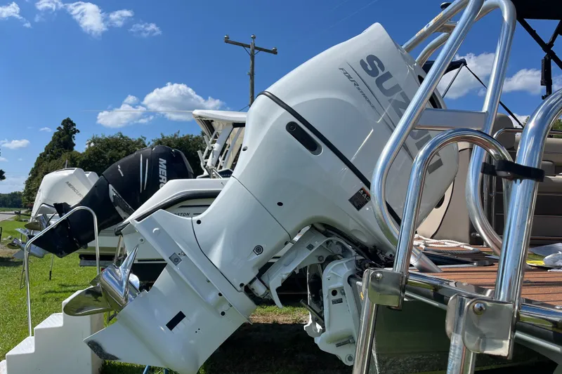 Slide: The Image of 2023 Bentley Pontoons 220 Elite Admiral with Suzuki outboard motor, parked outdoors. - 1