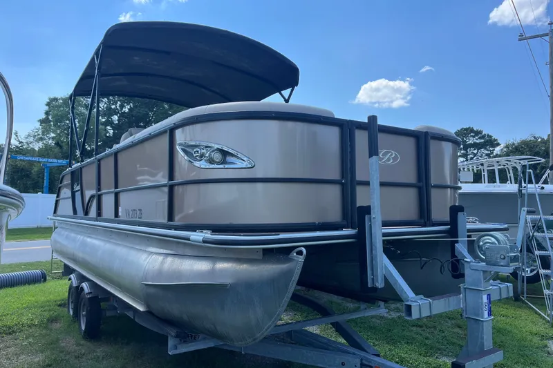 Slide: The Image of 2023 Bentley Pontoons 220 Elite Admiral on trailer, under blue sky. - 21