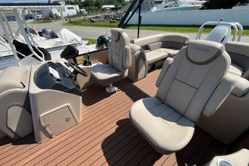 Slide: The Image of 2023 Bentley Pontoons 220 Elite Admiral interior with luxurious seating and modern helm. - 12
