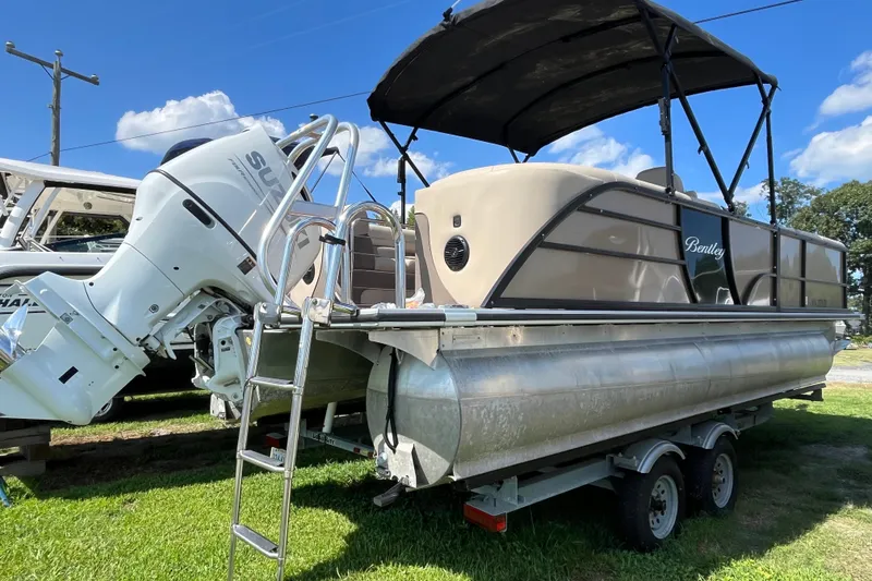 Slide: The Image of 2023 Bentley Pontoons 220 Elite Admiral on trailer with Suzuki outboard motor. - 16