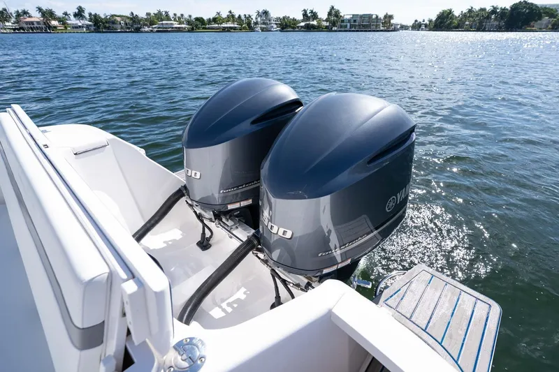 Slide: The Image of Twin Yamaha outboard engines on a 2021 Intrepid 327 Nomad boat, cruising on a sunny day. - 43