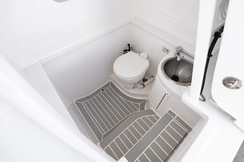 Slide: The Image of Compact bathroom in 2021 Intrepid 327 Nomad boat with toilet and sink. - 38