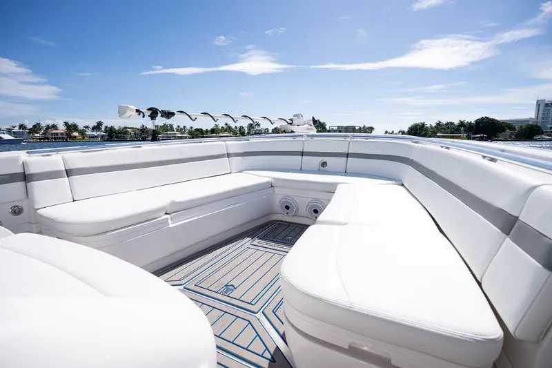 Slide: The Image of Luxurious seating on 2021 Intrepid 327 Nomad boat, under clear blue skies. - 29