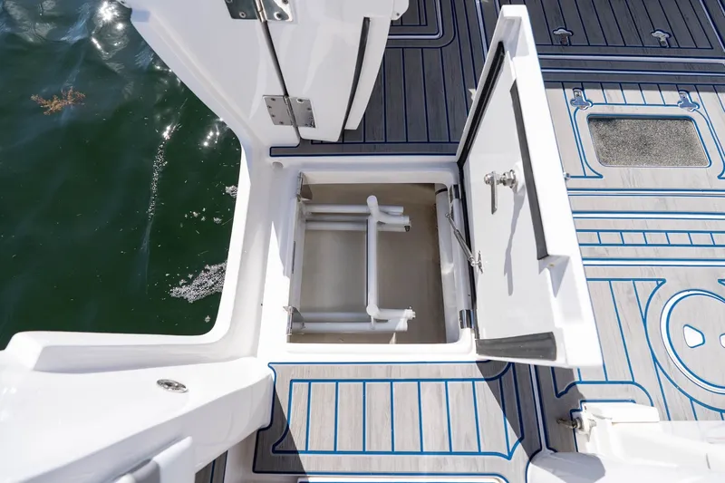 Slide: The Image of Open hatch on 2021 Intrepid 327 Nomad boat, revealing storage compartment. - 26