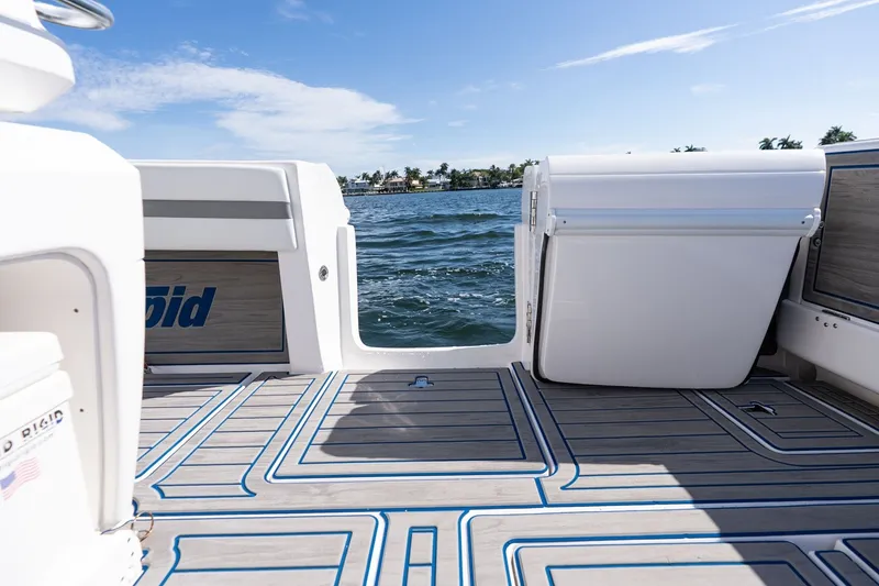 Slide: The Image of 2021 Intrepid 327 Nomad boat deck with ocean view and clear blue sky. - 27