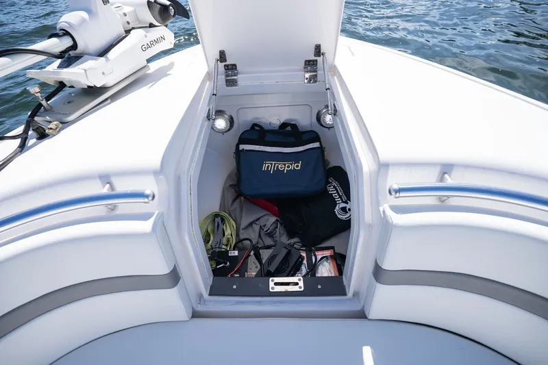 Slide: The Image of Storage compartment on 2021 Intrepid 327 Nomad boat with gear and equipment. - 35