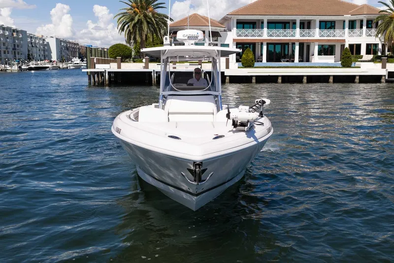 Slide: The Image of 2021 Intrepid 327 Nomad boat cruising near waterfront property. - 3