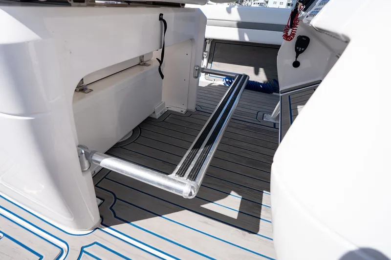 Slide: The Image of 2021 Intrepid 327 Nomad boat interior with sleek deck and modern features. - 25