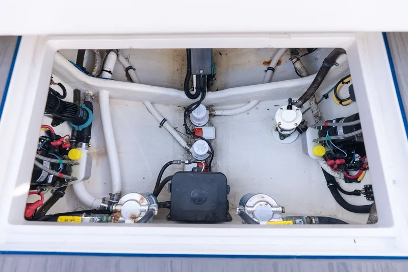 Slide: The Image of Engine compartment of a 2021 Intrepid 327 Nomad boat, showcasing mechanical components. - 41