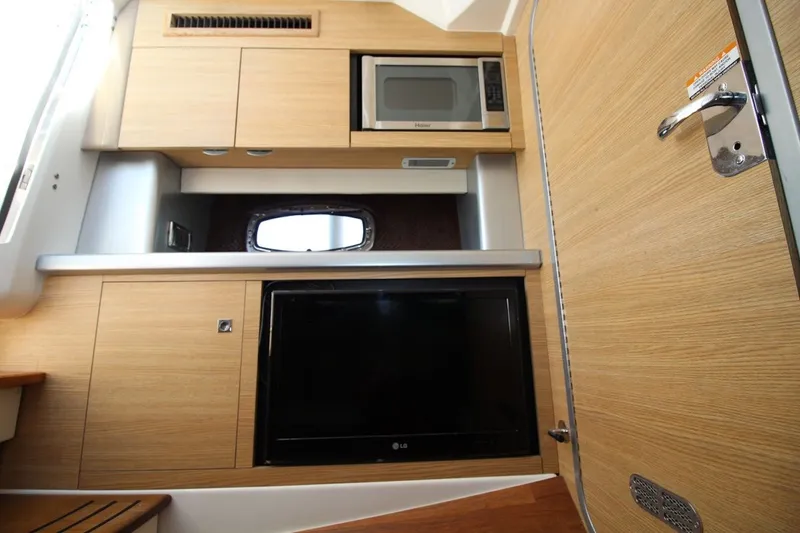 Slide: The Image of Interior of 2012 Chaparral 327 SSX boat with microwave and TV. - 24