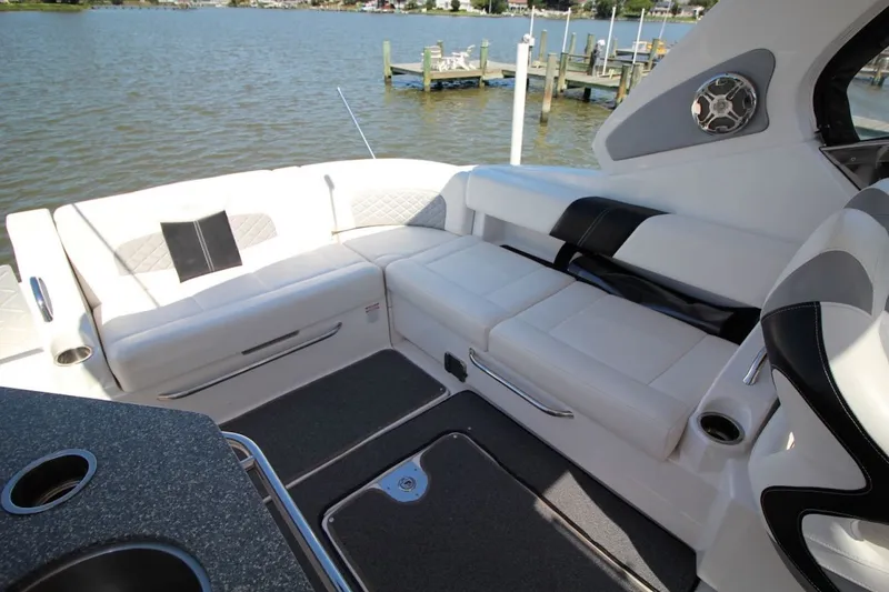 Slide: The Image of Luxurious seating area on a 2012 Chaparral 327 SSX boat by the water. - 13