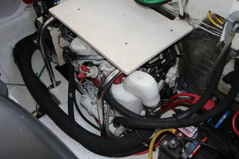 Slide: The Image of Engine compartment of a 2012 Chaparral 327 SSX boat, showing mechanical components and wiring. - 29