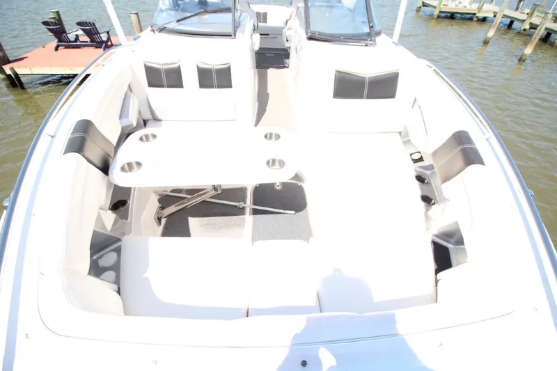 Slide: The Image of 2012 Chaparral 327 SSX boat interior with seating and table on water. - 20