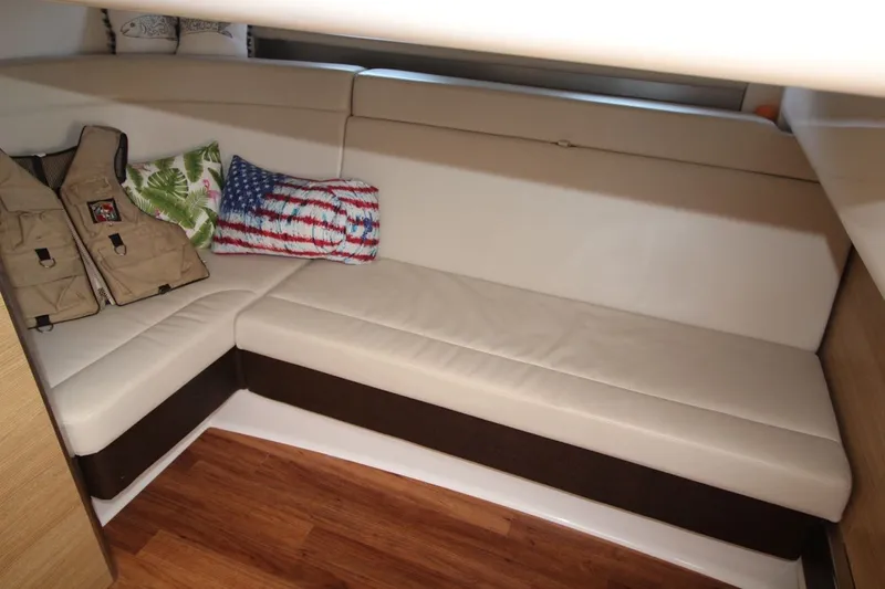 Slide: The Image of Interior of 2012 Chaparral 327 SSX boat with beige seating and decorative pillows. - 22