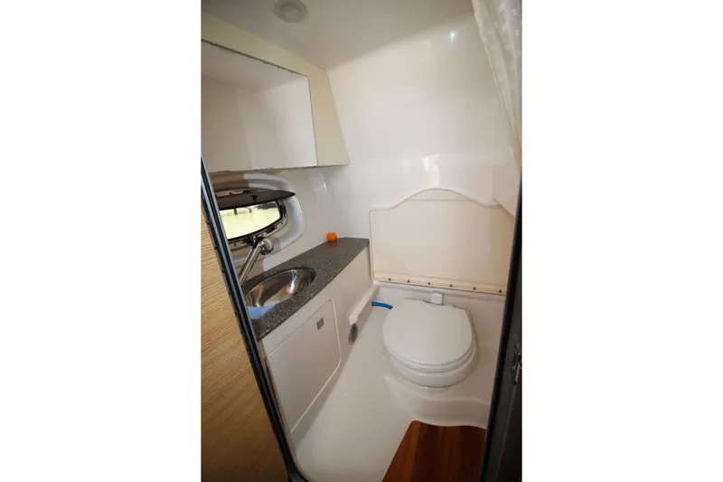 Slide: The Image of 2012 Chaparral 327 SSX boat bathroom with sink and toilet. - 25