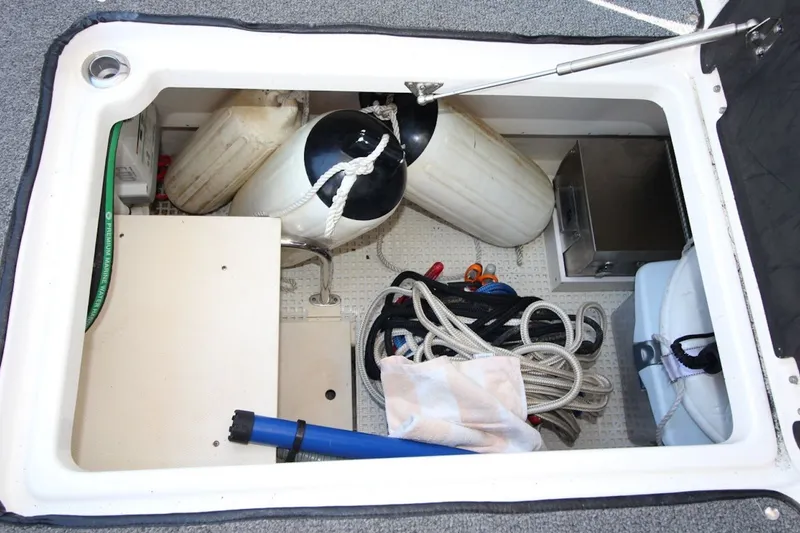 Slide: The Image of Storage compartment of 2012 Chaparral 327 SSX boat with ropes and equipment. - 15