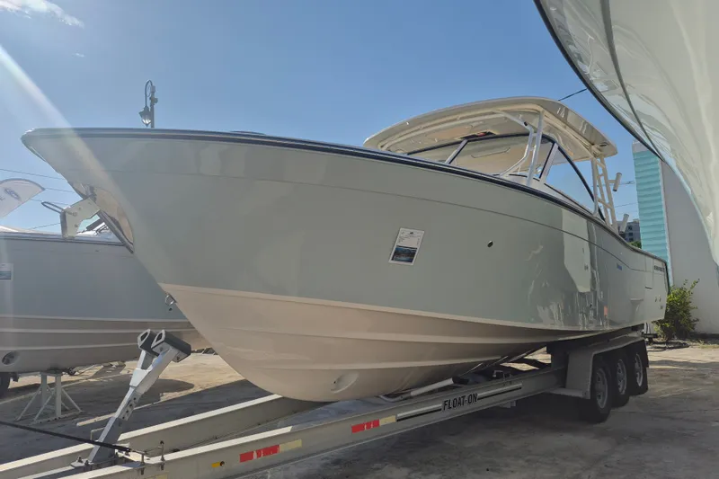 The Image of 2027 Grady-White Freedom 307 boat on trailer under clear blue sky. - 5