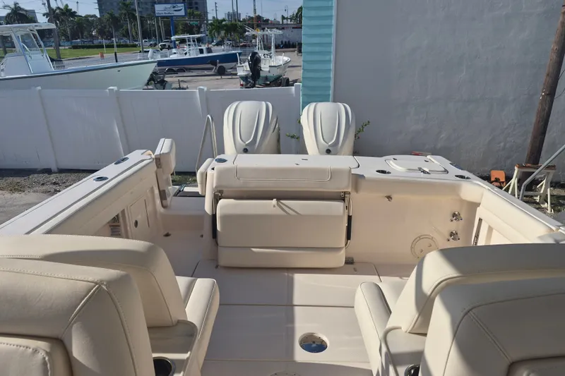 Slide: The Image of 2027 Grady-White Freedom 307 boat interior with seating and dual engines. - 21