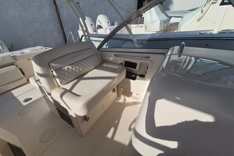 Slide: The Image of 2027 Grady-White Freedom 307 boat interior with cushioned seating and helm station. - 18