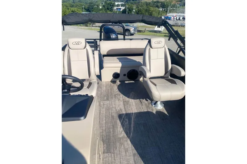 Slide: The Image of 2026 Bentley Pontoons Legacy 243 Swingback interior with beige seating and modern design. - 15