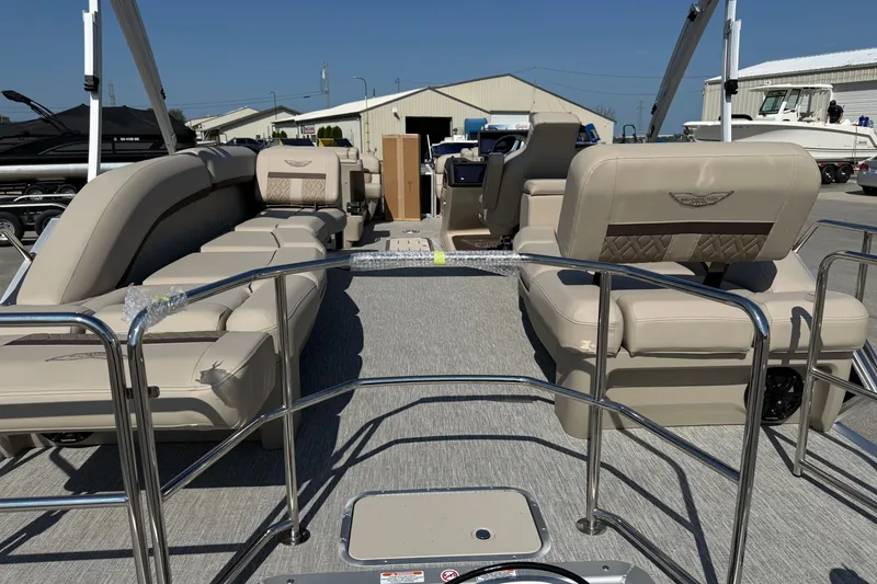 Slide: The Image of 2027 Bennington 23 MSL pontoon boat with beige seating and chrome railings. - 4